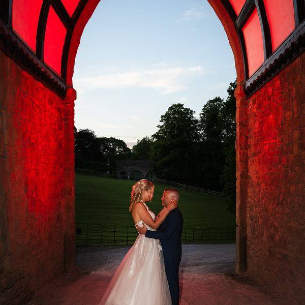 Couple under red arch