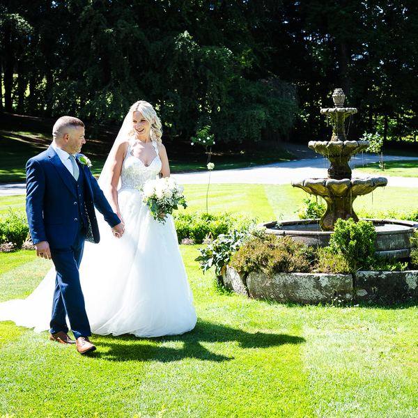 Couple walking by fountain